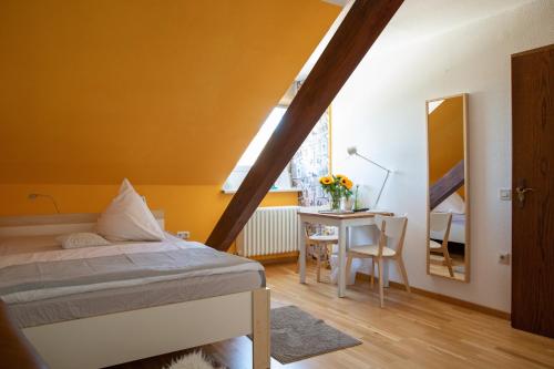 a bedroom with a bed and a desk with a mirror at Scheid´s Hotel – Restaurant in Wasserliesch