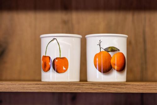 two cups with fruit on them sitting on a shelf at STAUDACH - Alpinresidenz Zillertal in Ramsau im Zillertal