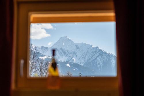 a person looking out a window at a mountain at STAUDACH - Alpinresidenz Zillertal in Ramsau im Zillertal