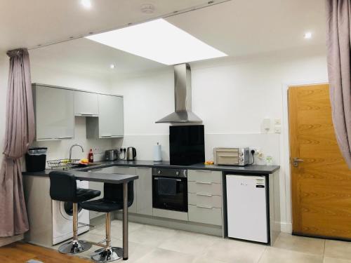 a kitchen with a counter and a stove top oven at Whiteley’s Cottages studio in Dumbarton