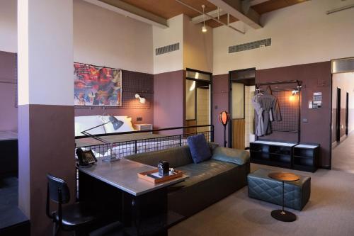 a living room with a couch and a table at URSIDE Hotel Shanghai The Bund in Shanghai