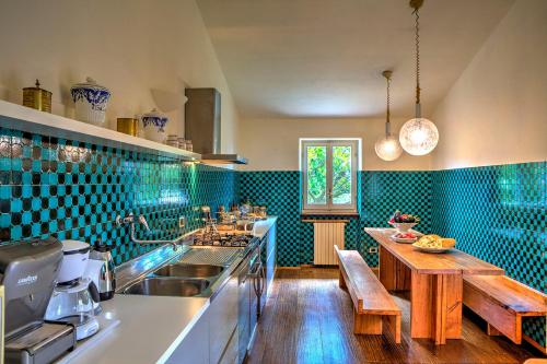 a kitchen with a sink and a wooden table at Casa Degli Oleandri 8, Emma Villas in Foligno