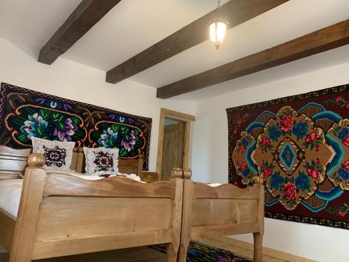 a bedroom with a wooden bed in a room at Conacul maramureșean Bilgăr in Bogdan Vodă