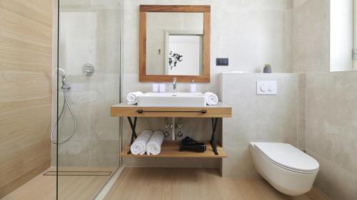 a bathroom with a sink and a toilet and a mirror at Villa Grgo by Villas Holiday in Tinjan
