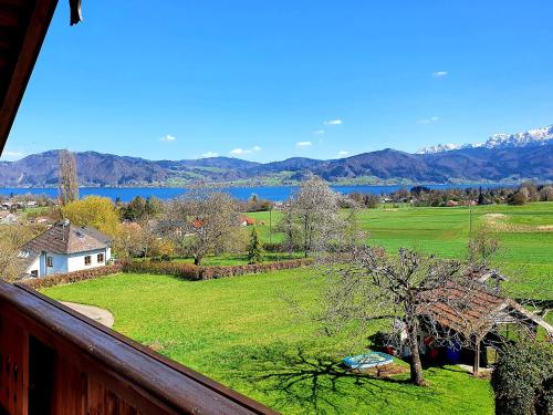 a view from a balcony of a field and a lake at Haus Leitner in Attersee am Attersee