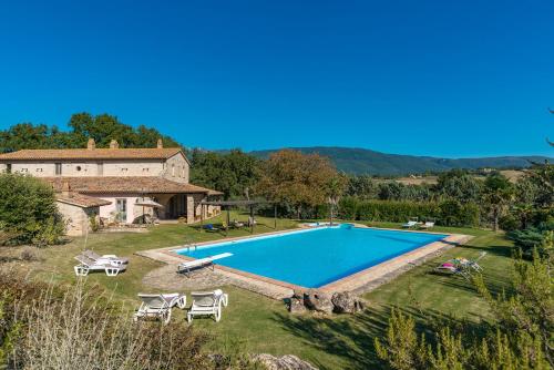an external view of a villa with a swimming pool at Casale Cicognola 12, Emma Villas in Massa Martana