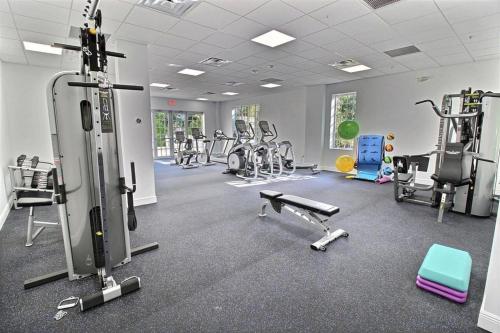 a gym with several treadmills and exercise bikes at LICENSED Mgr - LUXURY VIP PENTHOUSE SUITE - OFFERS RESORTS BEST PANORAMIC OCEAN VIEWS! in Key Largo