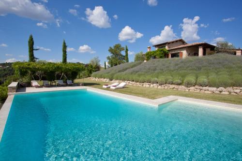 a large swimming pool in front of a house at CASALE DELLE LAVANDE 10, Emma Villas in Todi