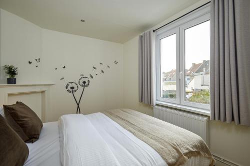 Un pat sau paturi într-o cameră la Trendy, authentieke woning met groot terras en tuin