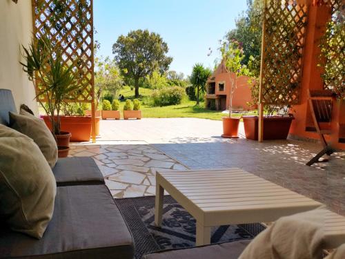 a patio with a table and a view of a yard at Home Garden in Siniscola