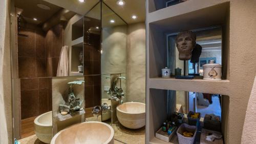 a bathroom with a toilet and a sink and a mirror at IL CASTELLACCIO 8, Emma Villas in Brisighella