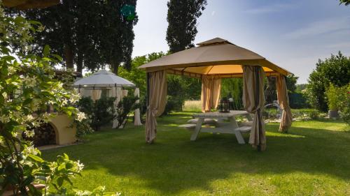 a gazebo and a picnic table in a yard at La Casa Di Nanì 8, Emma Villas in Forlì