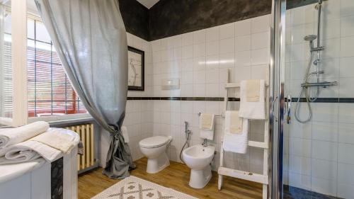 a bathroom with two toilets and a shower at La Casa Di Nanì 8, Emma Villas in Forlì