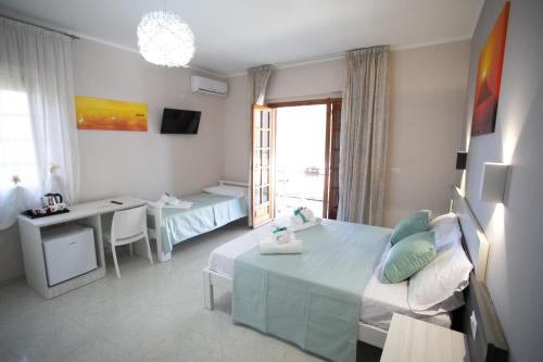 a room with a bed and a table and a desk at B&B Leonida in Tropea