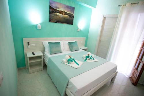 a bedroom with a bed with two dolls on it at B&B Leonida in Tropea
