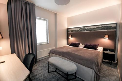 a hotel room with a bed and a window at SpaHotel Hamina in Hamina