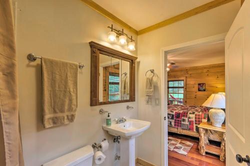 een badkamer met een wastafel, een spiegel en een bed bij Riverfront Marshall Escape with Mountain Views! in Marshall