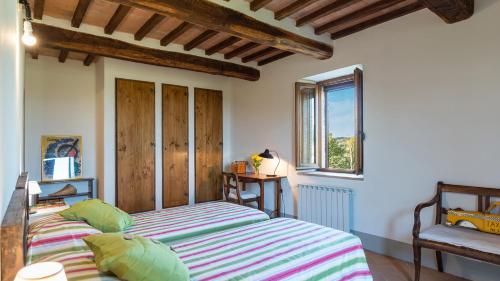 a bedroom with a bed and a window at PODERE FABBRICA 12, Emma Villas in Città della Pieve