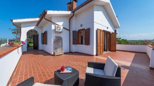 a patio of a house with chairs and a table at RIPARI DI GIOBBE 6&2, Emma Villas in Ortona