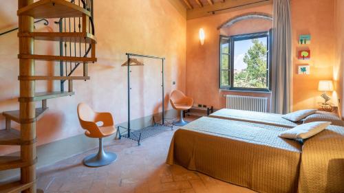 a bedroom with a bed and a staircase in a room at TERRIPI 10, Emma Villas in Pomarance
