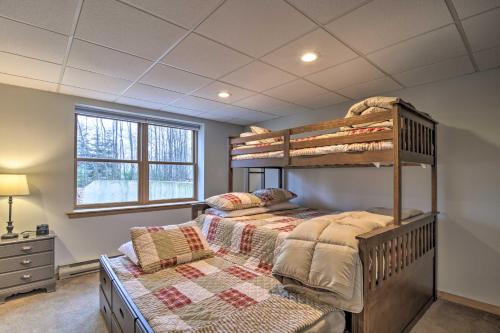 a bedroom with two bunk beds and a window at Secluded Gaylord Cabin with Deck, Fire Pit and Grill! in Gaylord