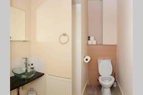 a bathroom with a toilet and a sink at Avenham Apartments in Preston