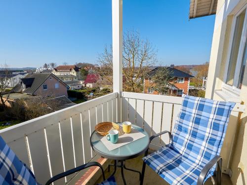 a table and two chairs on a balcony with a view at Wohnpark Stadt Hamburg Wohnung 56 in Binz