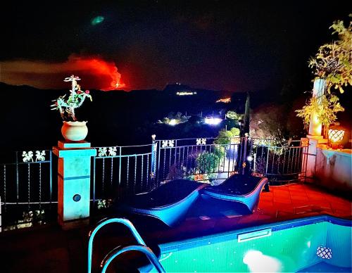 a backyard at night with a fire in the background at Villa Laura in Savoca 