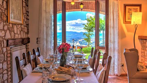 a table in a room with a large window at Villa Bella 8, Emma Villas in Massa Martana