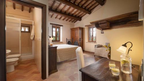 a bedroom with a bed and a bathroom at Villa Di Morice 14, Emma Villas in Castel Ritaldi