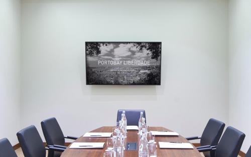 a conference room with a long table and chairs at PortoBay Liberdade in Lisbon
