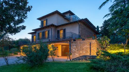 a large house with a balcony on top of it at Villa Fiorentini 10, Emma Villas in Barberino di Val dʼElsa
