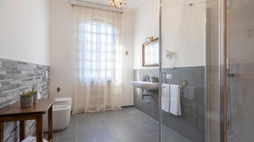 a bathroom with a shower and a toilet and a sink at Villa Fiorentini 10, Emma Villas in Barberino di Val dʼElsa