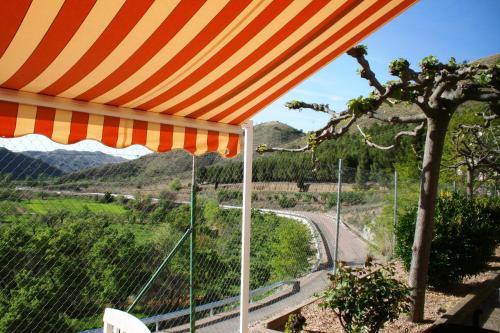 a view from a patio under an orange umbrella at Suite Rural Carenas in Carenas
