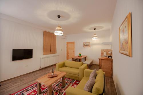 a living room with a couch and a table at Le Ranch in Cernik