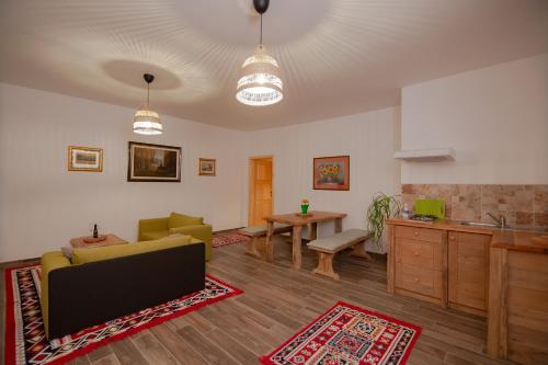 a living room with a couch and a table at Le Ranch in Cernik