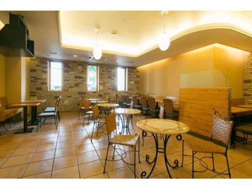 a restaurant with tables and chairs in a room at R&B Hotel Nagoya Nishiki - Vacation STAY 15171v in Nagoya
