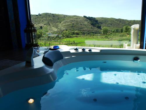 a hot tub with a view of a mountain at Suite Rural Carenas in Carenas