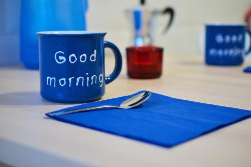 a blue cup sitting on a table with a spoon at Flat 93 in Naples