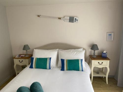 a bedroom with a bed with white sheets and pillows at La belle étoile chambres d'hôtes in Saint-Jean-de-Monts