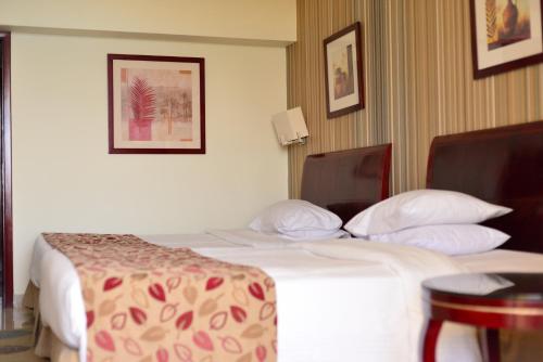 a hotel room with two beds and a table at Marina Sharm Hotel in Sharm El Sheikh