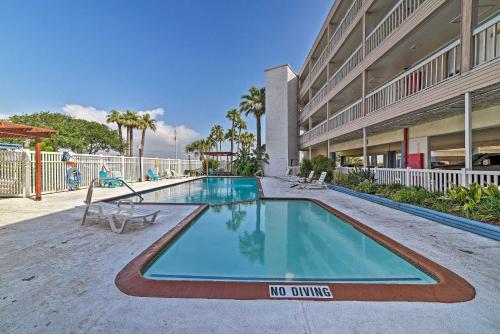 a swimming pool with a no dumping sign next to a building at Pool and Direct Beach Access Corpus Christi Escape in Corpus Christi