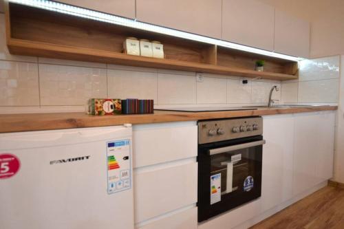 a kitchen with a stove and a counter top at View Apartments Belasica in Mokrievo