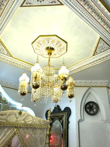 a chandelier hanging from a ceiling in a room at Suite Orientale Maison de L'église du Couvent in Narbonne