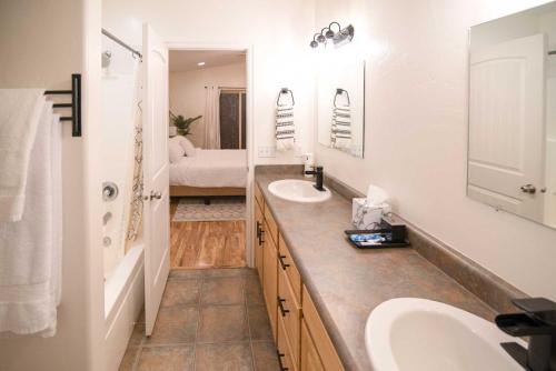 a white bathroom with two sinks and a tub at Modern Retreat with View, 9 Mi to Wahweap Beach! in Page