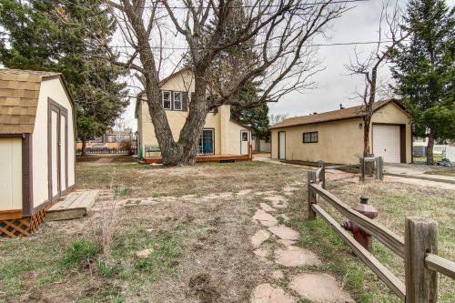 a house with a tree and a fence at Monument Retreat - Walk to Local Dining and Shopping in Monument