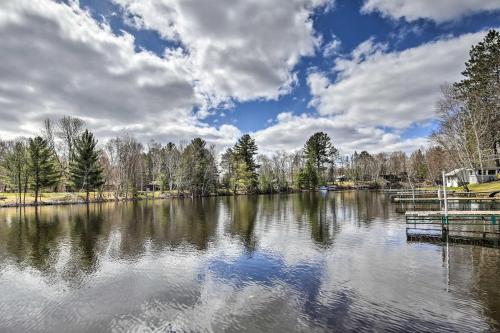 a large lake with trees and a cloudy sky at Lakeside Cabin with Fire Pit Near Pine Point Park! in Holcombe