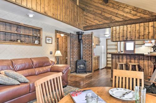 a living room with a couch and a table at Cozy Log Cabin Escape In the Heart of Creede! in Creede