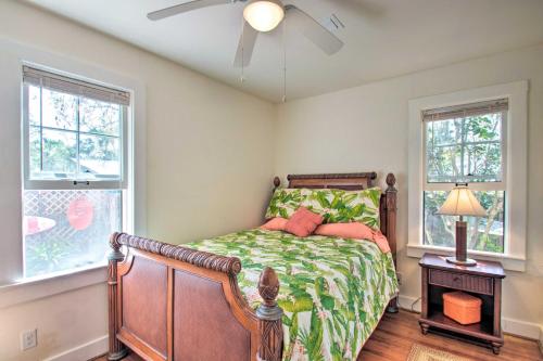 a bedroom with a bed and two windows at Colorful Pensacola Oasis 1 Block to Bayview Park! in Pensacola
