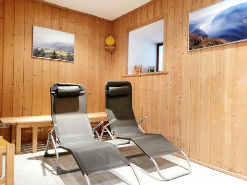 two chairs in a room with wood paneling at Haus Leitner in Attersee am Attersee